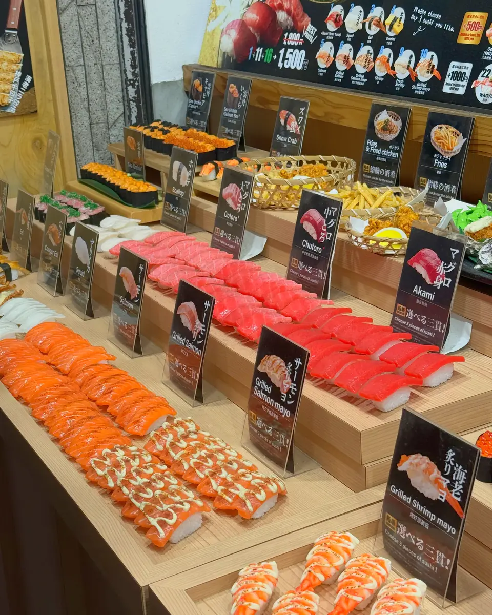 Sushi and sashimi laid out at a Nishiki Market storefront
