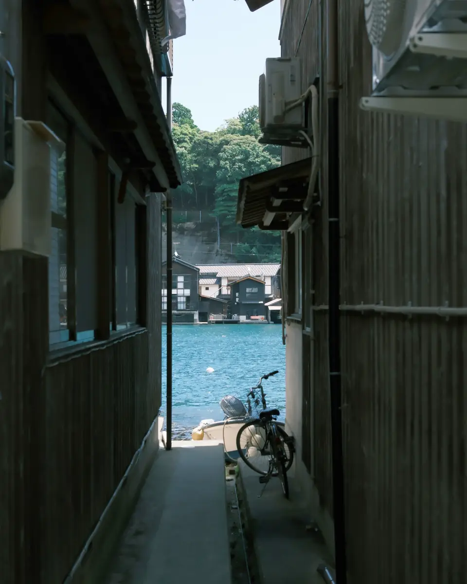 A lane between boathouses leading to the sea in Ine