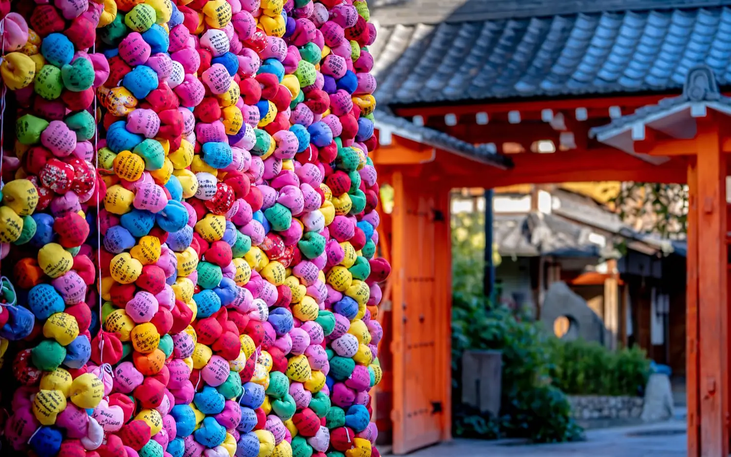 Coloured kukurizaru balls hanging at the gate of Yasaka Koshin-do