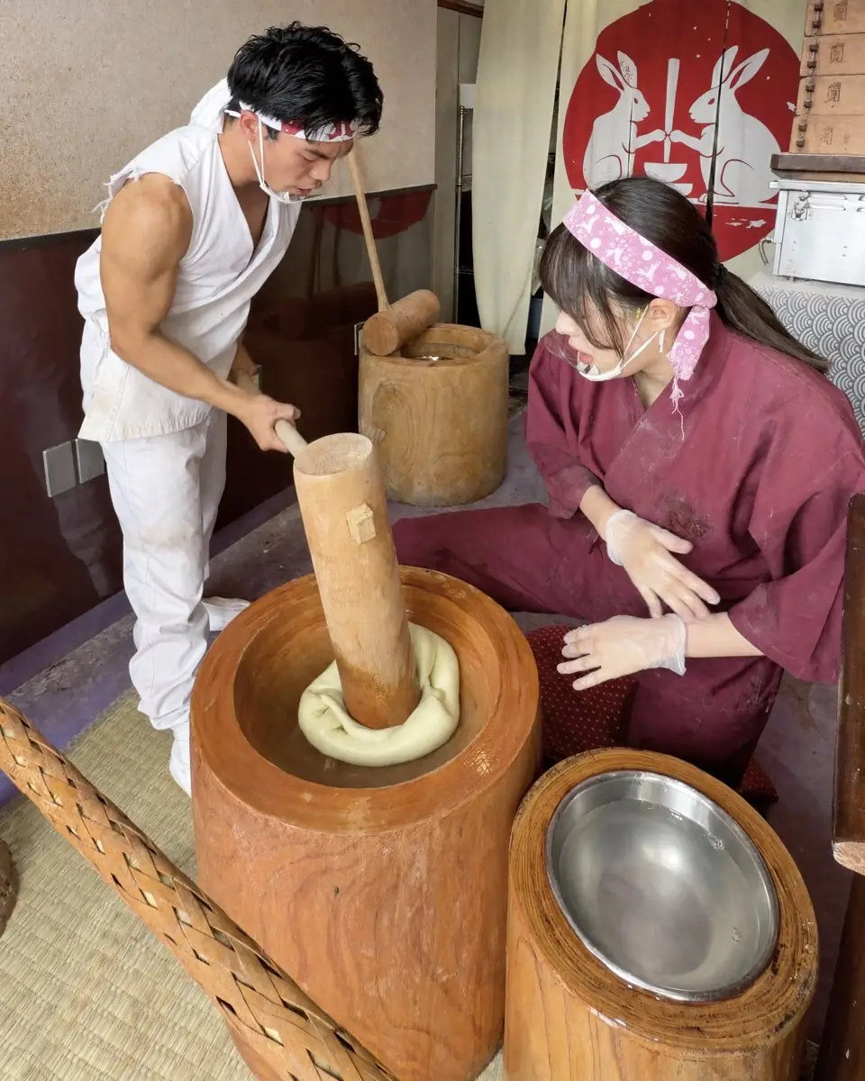 Rice cakes being pounded in front of the shop at Mochi-Mochi