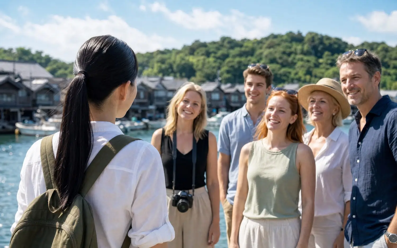 A guide and travellers at the boat houses of Ine
