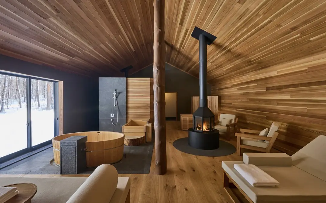 A villa room at AZUMA FARM Koiwai with a fireplace and a bath